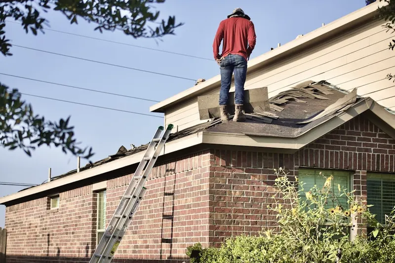 Professional roofer working on a residential roof in Rexburg